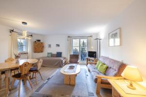 a living room with a couch and a table at 2206 Frisch renovierte Wohnung mit modernem Ambiente in Vulpera