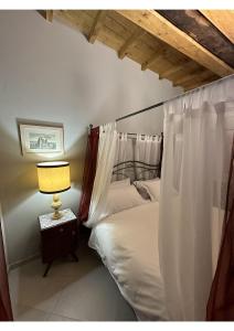 una camera con un letto e una lampada su un tavolo di Appartamenti La Vecchia Latteria a Ceva
