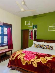 a bedroom with a bed with a green wall at The Last Try - Secret Ashram Coorg in Siddapur