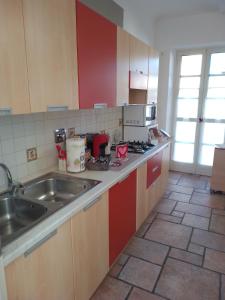 a kitchen with a sink and a counter top at Lovely apartment with terrace by Alterego in Villanova dʼAsti