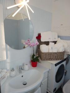a bathroom with a sink and a mirror at Lovely apartment with terrace by Alterego in Villanova dʼAsti