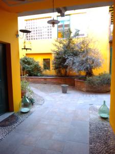 a courtyard with vases in the middle of a building at Lovely apartment with terrace by Alterego in Villanova dʼAsti