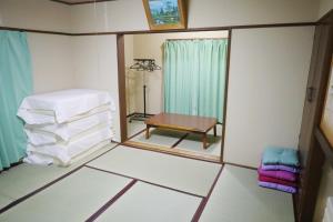 a small room with a mirror and a table at Luna House in Nakano