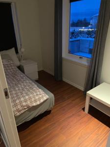 - une chambre avec un lit et une grande fenêtre dans l'établissement Paul’s house, à Ågotnes