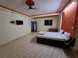a bedroom with a bed and a wooden floor at Wonderhills lodge in Hinjewadi
