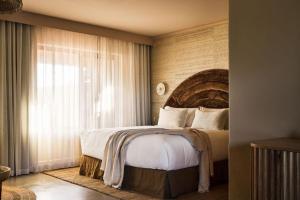 A bed or beds in a room at Swell Hotel Byron Bay - Adults Only