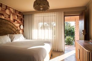 A bed or beds in a room at Swell Hotel Byron Bay - Adults Only