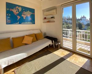 a living room with a couch and a large window at Nest in Mets in Athens