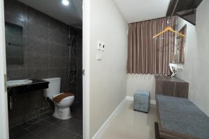 a bathroom with a toilet and a sink at We Resident Hotel in Hat Yai