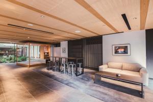 a living room with a couch and a bar at KABIN Taka in Kyoto