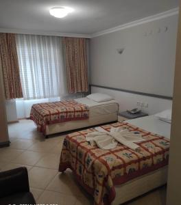 a hotel room with two beds in a room at OTEL DEFNE in Polatlı
