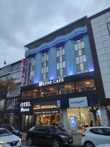 a blue building with cars parked in front of it at OTEL DEFNE in Polatlı
