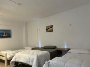 a room with three beds and a table with lights at Apartamento Buensuceso 46 VFTGR04774 in Granada