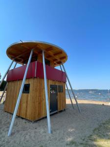 a small building on the beach near the ocean at Horami Villa - HANAMI Apartment in Malchow +10 photos