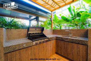 an outdoor kitchen with a stove and a sink at Son&Henry Zenity District 1 in Ho Chi Minh City