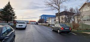 a group of cars driving down a street at Keflavik Cozy Apartment in Keflavík