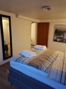 a bedroom with a bed with two towels on it at Keflavik Cozy Apartment in Keflavík