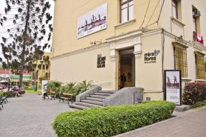 a building with stairs in front of a building at Larq'a Park Rooms in Lima