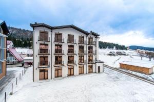 an aerial view of a building in the snow at GARDA - Breakfast included in the price Restaurant Free Parking Mountain view Kitchen in the apartment separate entrance in Bukovel