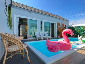 a pink inflatable flamingo in a swimming pool at Khiangkhoo Pool Villa ChiangKhan - เคียงคู่พูลวิลล่าเชียงคาน in Chiang Khan