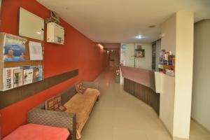 a hospital hallway with a bench and a counter at Hotel Isher International in Gandhinagar