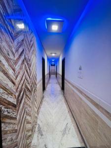 a long hallway with blue lights in a building at HOTEL S S PALACE in Agra