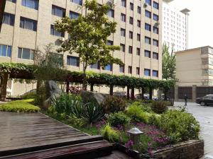 a garden in front of a large building at Xi'an Bell Tower Atour S Wu Hotel in Xi'an