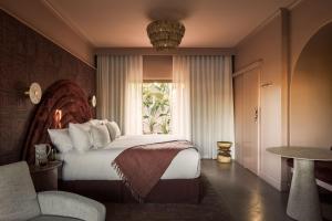A bed or beds in a room at Swell Hotel Byron Bay - Adults Only