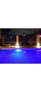 a view of a swimming pool at night at Paseo De La Cisterna UF 320 in Buenos Aires