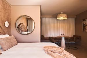 A bed or beds in a room at Swell Hotel Byron Bay - Adults Only