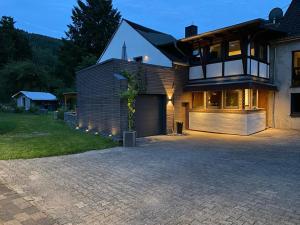 a house with a driveway in front of it at Dhrontalstube in Gräfendhron