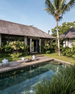 a villa with a swimming pool and a house at Bedulu Cliff Estate Villas Complex Ubud in Ubud