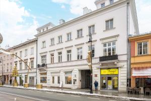 a white building on the side of a street at Nowy Świat 22 Luxury Apartment in Warsaw