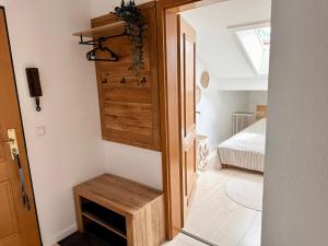 a small room with a bed and a wooden door at Ferienwohnung Alphorn - SommerBergBahn unlimited kostenlos in Oberstdorf