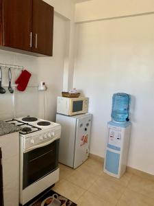 a kitchen with a stove and a microwave and a refrigerator at Rorot 1 bedroom Kapsoya with free wifi and great views! in Eldoret