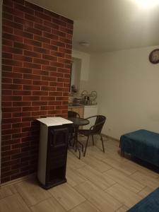 a living room with a brick wall and a table and chairs at U Gabrysia i Tatiany in Ustrzyki Górne