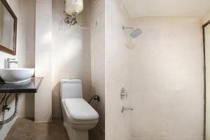 a bathroom with a toilet and a sink at FabExpress The Premium Villa in New Delhi