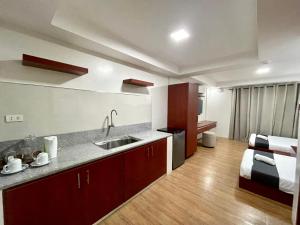 A kitchen or kitchenette at Staycation Hotel