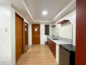 A kitchen or kitchenette at Staycation Hotel