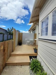 a wooden deck next to a house at Character 1-Bedroom Unit in Masterton