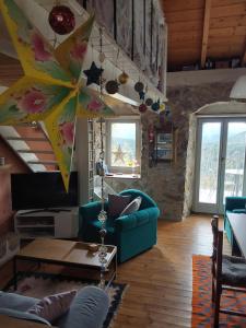 a living room with a blue couch and a table at The Artist's House in Psárion
