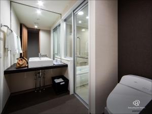 a bathroom with a sink and a toilet at Daiwa Roynet Hotel Tokushima Ekimae in Tokushima