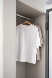 a white shirt is hanging on a rack at Casa Kaleido in Trento
