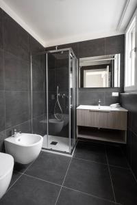 a bathroom with a shower and a sink and a toilet at Casa Kaleido in Trento