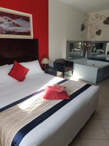 Postel nebo postele na pokoji v ubytování Green Hotel Ninfa
