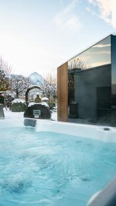a swimming pool in a house in the snow at Best Western Hotel am Walserberg in Wals