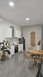 瓦倫西亞的住宿－Imperial Apartamentos Puerto，一间带桌椅的厨房和一间用餐室