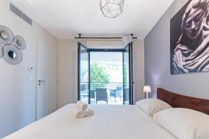 una camera da letto con un letto e due asciugamani di Vue Monaco & Tour Odéon, Terrasse, Parking Gratuit a Beausoleil