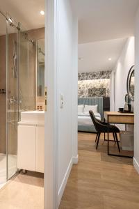 a bathroom with a shower and a bedroom with a bed at Kriel Suites by LIV Homes in Athens +98 photos