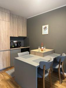 a kitchen with a counter and a table and chairs at Family Corner Bjelašnica in Bjelašnica